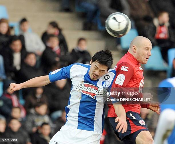 Lille's Florent Balmont vies with Grenoble's midfielder Daisuke Matsui during their French L1 football match on March 14, 2010 in Villeneuve-d'Ascq....