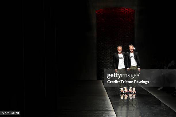 Fashion designers Dean and Dan Caten acknowledges the audience on the runway at the Dsquared2 show during Milan Men's Fashion Week Spring/Summer 2019...