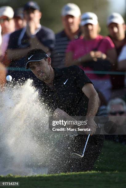 Charl Schwartzel of South Africa hits out of the bunker on the 15th hole during the final round of the 2010 WGC-CA Championship at the TPC Blue...