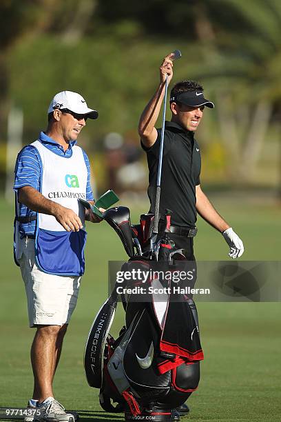 Charl Schwartzel of South Africa pulls a club from his bag on the 14th hole during the final round of the 2010 WGC-CA Championship at the TPC Blue...