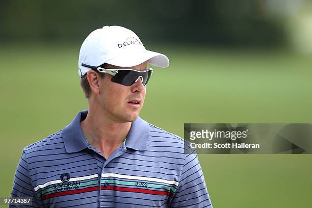 Henrik Stenson of Sweden plays a shot on the seventh hole during the final round of the 2010 WGC-CA Championship at the TPC Blue Monster at Doral on...