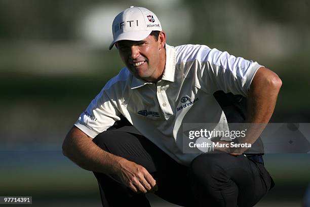 Padraig Harrington of Ireland lines up a putt on the 11th hole during the final round of the 2010 WGC-CA Championship at the TPC Blue Monster at...
