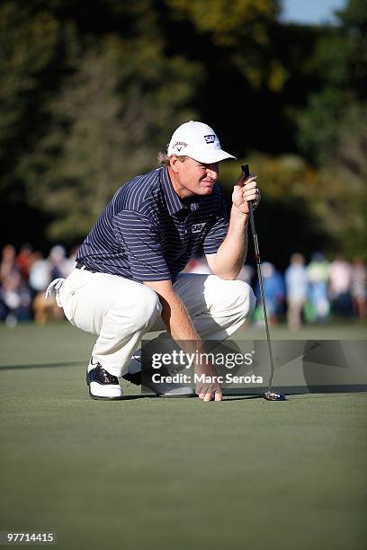 Ernie Els of South Africa lines up a putt on the 16th hole during the final round of the 2010 WGC-CA Championship at the TPC Blue Monster at Doral on...