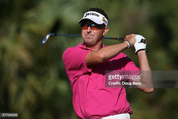 Robert Allenby of Australia tees off on the 13th tee box during the final round of the 2010 WGC-CA Championship at the TPC Blue Monster at Doral on...