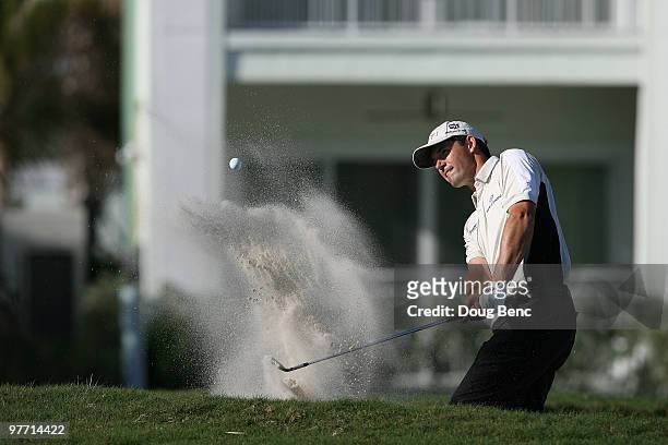 Padraig Harrington of Ireland plays a shot on the 13th hole during the final round of the 2010 WGC-CA Championship at the TPC Blue Monster at Doral...