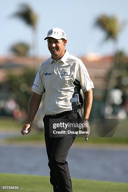 Padraig Harrington of Ireland smiles after making a birdie shot on the tenth hole during the final round of the 2010 WGC-CA Championship at the TPC...