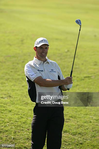 Padraig Harrington of Ireland hits his approach shot on the 11th hole during the final round of the 2010 WGC-CA Championship at the TPC Blue Monster...