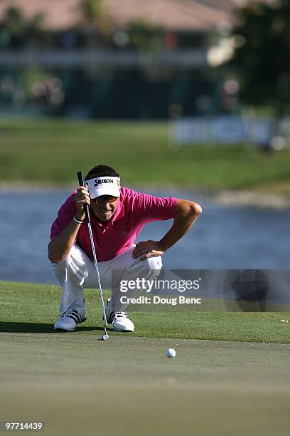 Robert Allenby of Australia lines up a par putt on the tenth hole during the final round of the 2010 WGC-CA Championship at the TPC Blue Monster at...