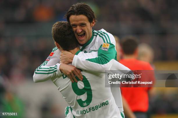 Edin Dzeko of Wolfsburg celebrates the second goal with Christian Gentner of Wolfsburg during the Bundesliga match between Borussia Moenchengladbach...