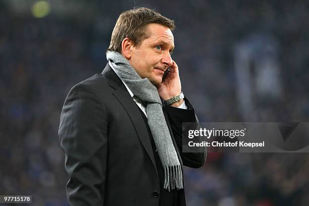 Manager Horst of Stuttgart telephones before the Bundesliga match between FC Schalke 04 and VfB Stuttgart at the Veltins Arena on March 12, 2010 in...