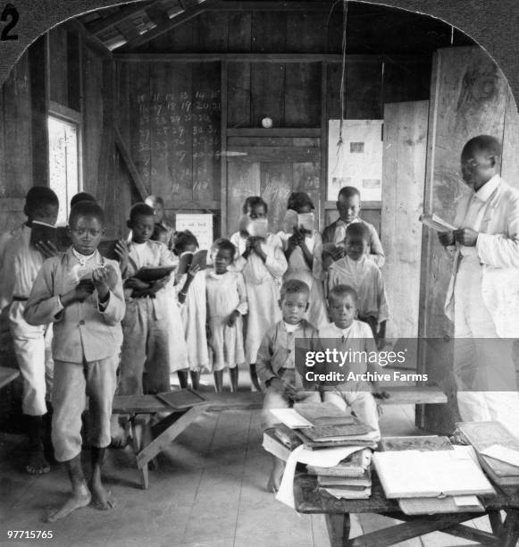 Native Jamaican school children reciting in the rough school house, Jamaica