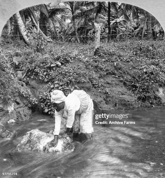 Washing clothes in a stream, Jamaica