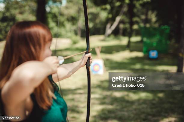 female archer in the fieald - arco de arqueiro imagens e fotografias de stock