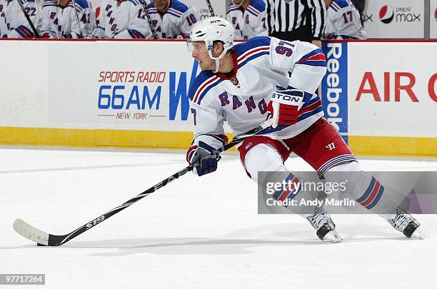 Matt Gilroy of the New York Rangers plays the puck against the New Jersey Devils during the game at the Prudential Center on March 10, 2010 in...