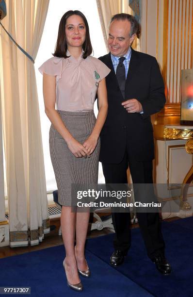 French Actress Marion Cotillard poses with French Minister of Culture Frederic Mitterrand after being awarded the Order of Arts and Letters at...