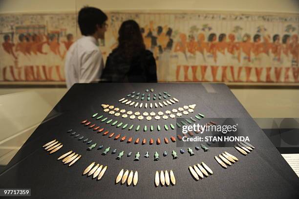 Miscellaneous floral pendants made of faience from the ancient Egyptian New Kingdom, Dynasty 18 or 19 on display as a couple view "Part of the...