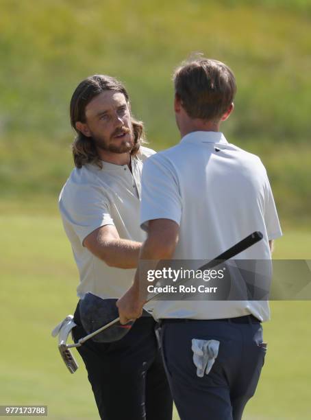 Tommy Fleetwood of England shakes hands with Russell Henley of the United States on the 18th green during the final round of the 2018 U.S. Open at...