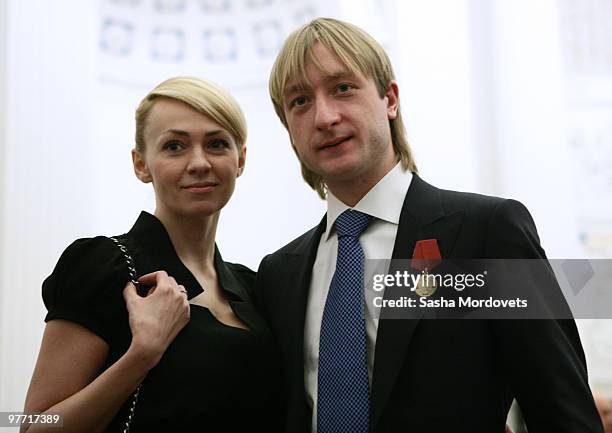 Silver medalist figure skater Evgeni Plushenko and his wife producer Yana Rudkovskaya attend a ceremony at the Kremlin March 15, 2010 in Moscow,...