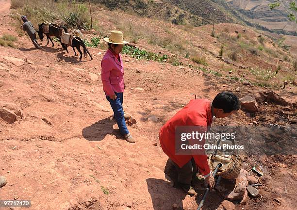 Villagers get water at a drinking water supply point on March 15, 2010 in Huili County of Liangshan Yi Autonomous Prefecture, Sichuan Province,...