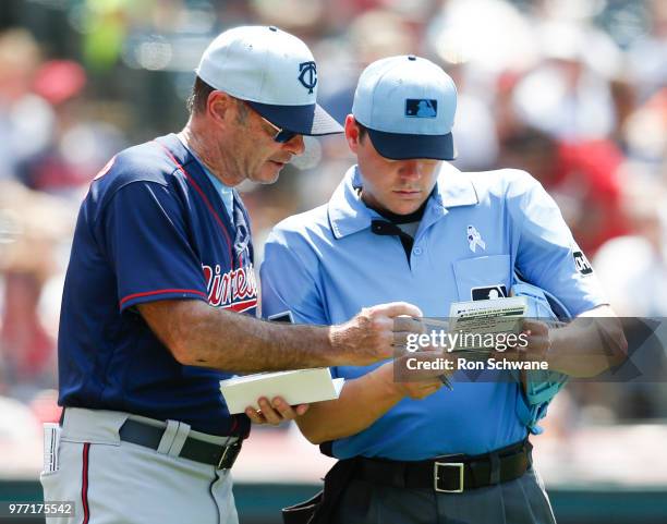 Manager Paul Molitor of the Minnesota Twins talks with home plate umpire DJ Reyburn to insert a pinch runner against the Cleveland Indians during the...