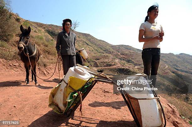 Villagers wait to get water at a drinking water supply point on March 15, 2010 in Huili County of Liangshan Yi Autonomous Prefecture, Sichuan...