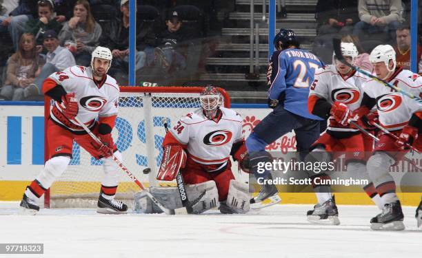 Manny Legace of the Carolina Hurricanes makes a save against Chris Thorburn of the Atlanta Thrashers at Philips Arena on March 7, 2010 in Atlanta,...