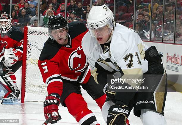 Evgeni Malkin of the Pittsburgh Penguins and Colin White of the New Jersey Devils skate for position during the game at the Prudential Center on...