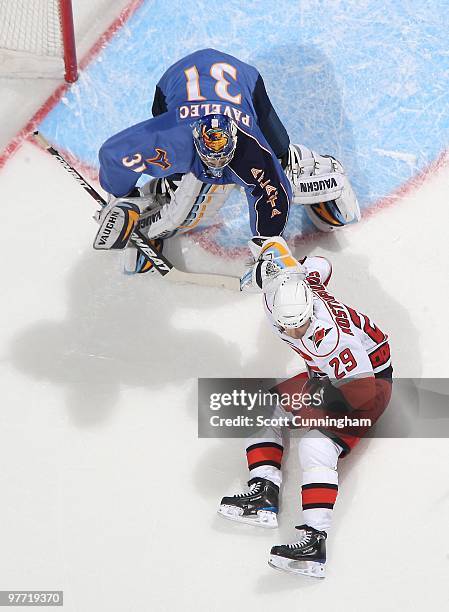 Ondrej Pavelec of the Atlanta Thrashers gets set for a shot against Tom Kostopolous of the Carolina Hurricanes at Philips Arena on March 7, 2010 in...