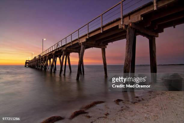 jetty at sunset, largs bay, adelaide, australia - bay adelaide stock pictures, royalty-free photos & images