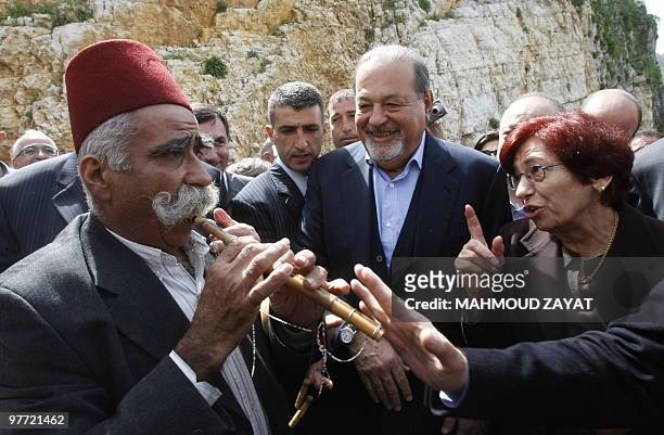 Lebanese villager playes a folkloric tune on a reed flute during a popular welcoming ceremony for Mexican tycoon Carlos Slim in his family's hometown...