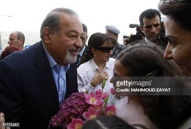 Mexican tycoon Carlos Slim is welcomed by locals during a visit to his family's hometown Jezzine in southern Lebanon on March 15, 2010. Slim, who has...