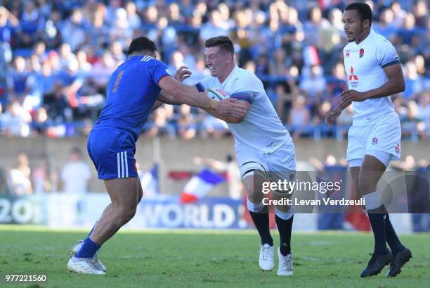 Ben Curry of England runs with ball and Jean Baptiste Gros of France tackles him during the World Rugby Under 20 Championship Final between England...