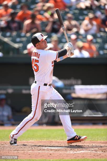 Mark Trumbo of the Baltimore Orioles hits a solo home run in seventh inning during a baseball game against the Miami Marlins at Oriole Park at Camden...