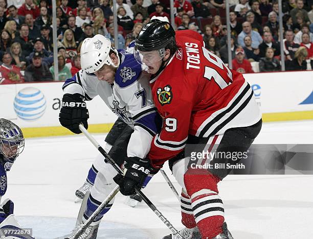 Jonathan Toews of the Chicago Blackhawks and Rob Scuderi of the Los Angeles Kings fight for the puck in front of goalie Jonathan Quick of the Kings...