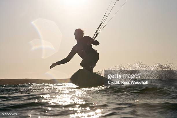 kite boarder in action. - ross woodhall stock pictures, royalty-free photos & images