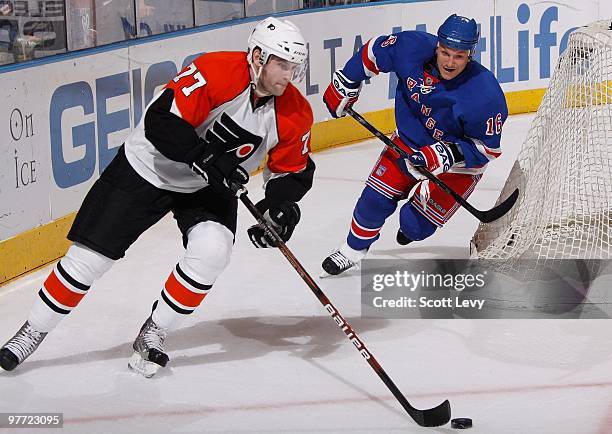 Ryan Parent of the Philadelphia Flyers skates with the puck under pressure by Sean Avery of the New York Rangers in the third period on March 14,...