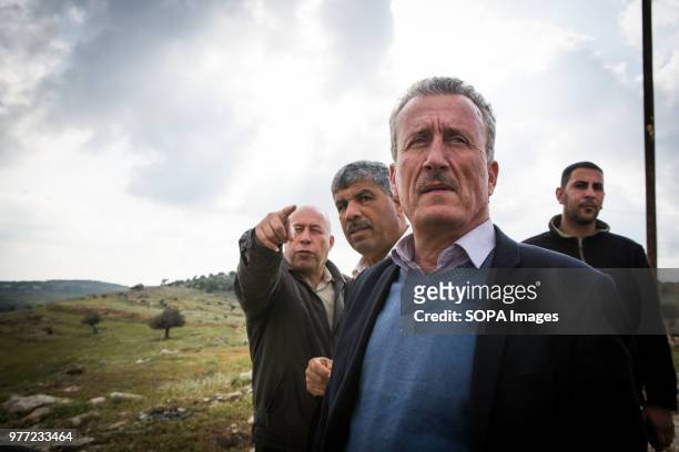 Ahed Tamimi's father goes on with his life. He is seen here with a government administrator, looking at the land around the small town of Nabi Salih....