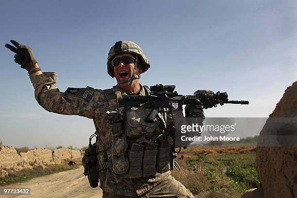 Army Lt. Scott Doyle shouts for his soldiers to reposition during an attack by Taliban insurgents on March 15, 2010 at Howz-e-Madad in Kandahar...