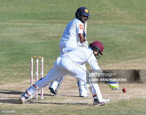 Niroshan Dickwella of Sri Lanka attempts to his pass Shane Dowrich of West Indies during day 4 of the 2nd Test between West Indies and Sri Lanka at...