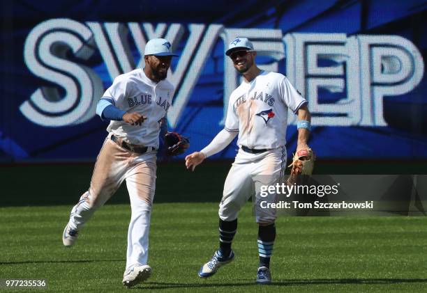 Teoscar Hernandez of the Toronto Blue Jays celebrates a victory with Randal Grichuk over the Washington Nationals at Rogers Centre on June 17, 2018...