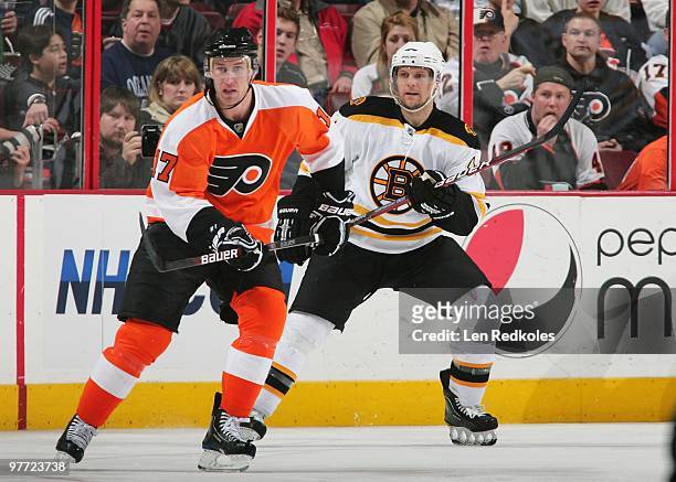 Jeff Carter of the Philadelphia Flyers skates against Dennis Seidenberg of the Boston Bruins on March 11, 2010 at the Wachovia Center in...