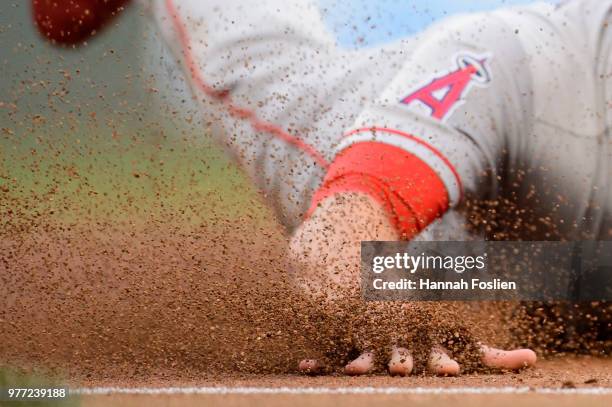 The hand of Zack Cozart of the Los Angeles Angels of Anaheim is seen as he slides safely into third base against the Minnesota Twins during the game...