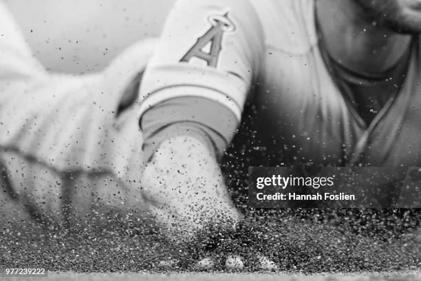 The hand of Zack Cozart of the Los Angeles Angels of Anaheim is seen as he slides safely into third base against the Minnesota Twins during the game...