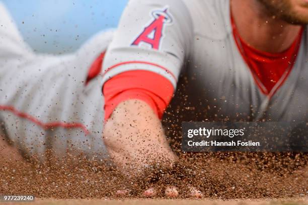 The hand of Zack Cozart of the Los Angeles Angels of Anaheim is seen as he slides safely into third base against the Minnesota Twins during the game...