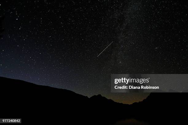 shooting star above bowman lake, glacier national park, montana - bowman lake stock pictures, royalty-free photos & images