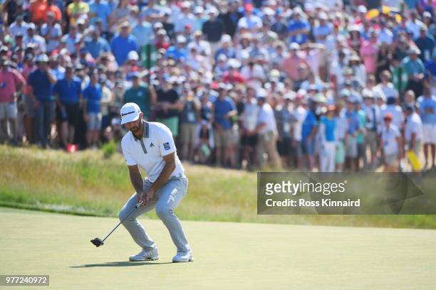 Dustin Johnson of the United States reacts to a missed putt on the ninth green during the final round of the 2018 U.S. Open at Shinnecock Hills Golf...