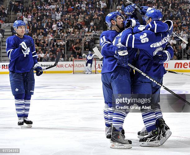 Luke Schenn of the Toronto Maple Leafs joins his team mates celebrating a third period goal against the Tampa Bay Lightning March 11, 2010 at the Air...