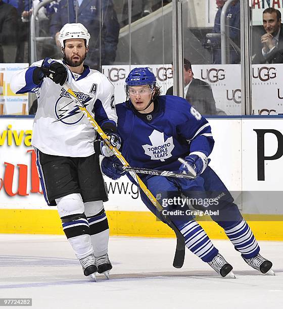 Martin St. Louis of the Tampa Bay Lightning skates with Mikhail Grabovski of the Toronto Maple Leafs during game action March 11, 2010 at the Air...