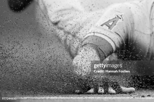 The hand of Zack Cozart of the Los Angeles Angels of Anaheim is seen as he slides safely into third base against the Minnesota Twins during the game...