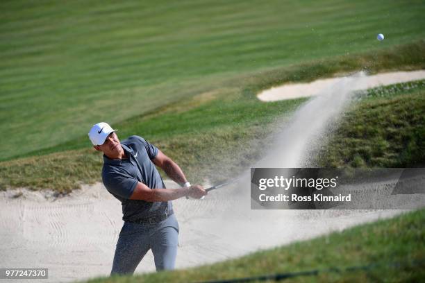 Brooks Koepka of the United States plays his third shot from a bunker on the 11th hole during the final round of the 2018 U.S. Open at Shinnecock...